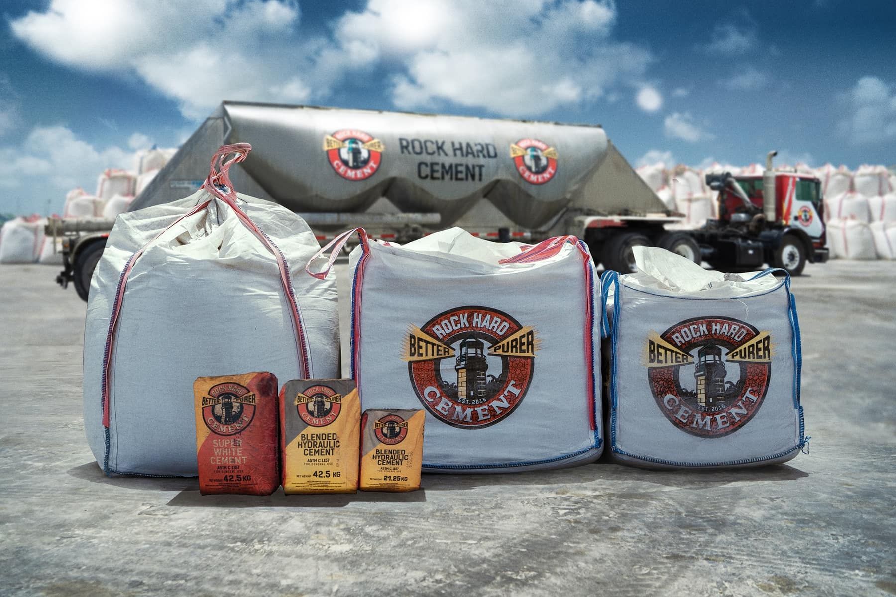 Rock Hard Cement retail bags and bulk sacks beside a delivery tanker
